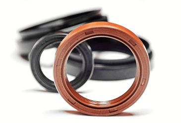 A close up of two oil seals which are essential components of your precision engineering machinery