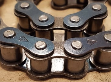 A power transmission roller chain on a workbench ready to be shown as an example to a new worker.